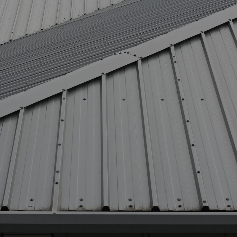 Gray metal roof with overlapping panels.